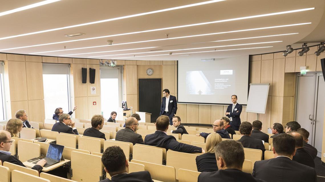 An angled view of an event being held in the Linklaters Lecture Hall from the rear of the room