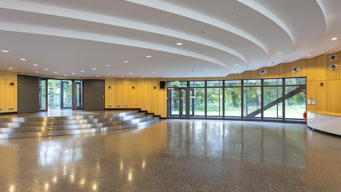Ground Level: A view of the foyer and highly customizable reception space; a sink and service counter are located on the far right edge of the image while steps leading to the upper level are visible in the background (not pictured: the elevator)