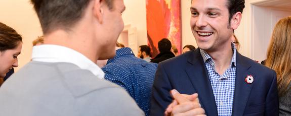 Two international program participants shake hands at a networking event