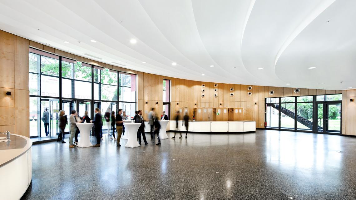 Ground Level: A view of the foyer and highly customizable reception space; a sink and service counter are located on the left edge of the image while the coat-check area is visible in the background
